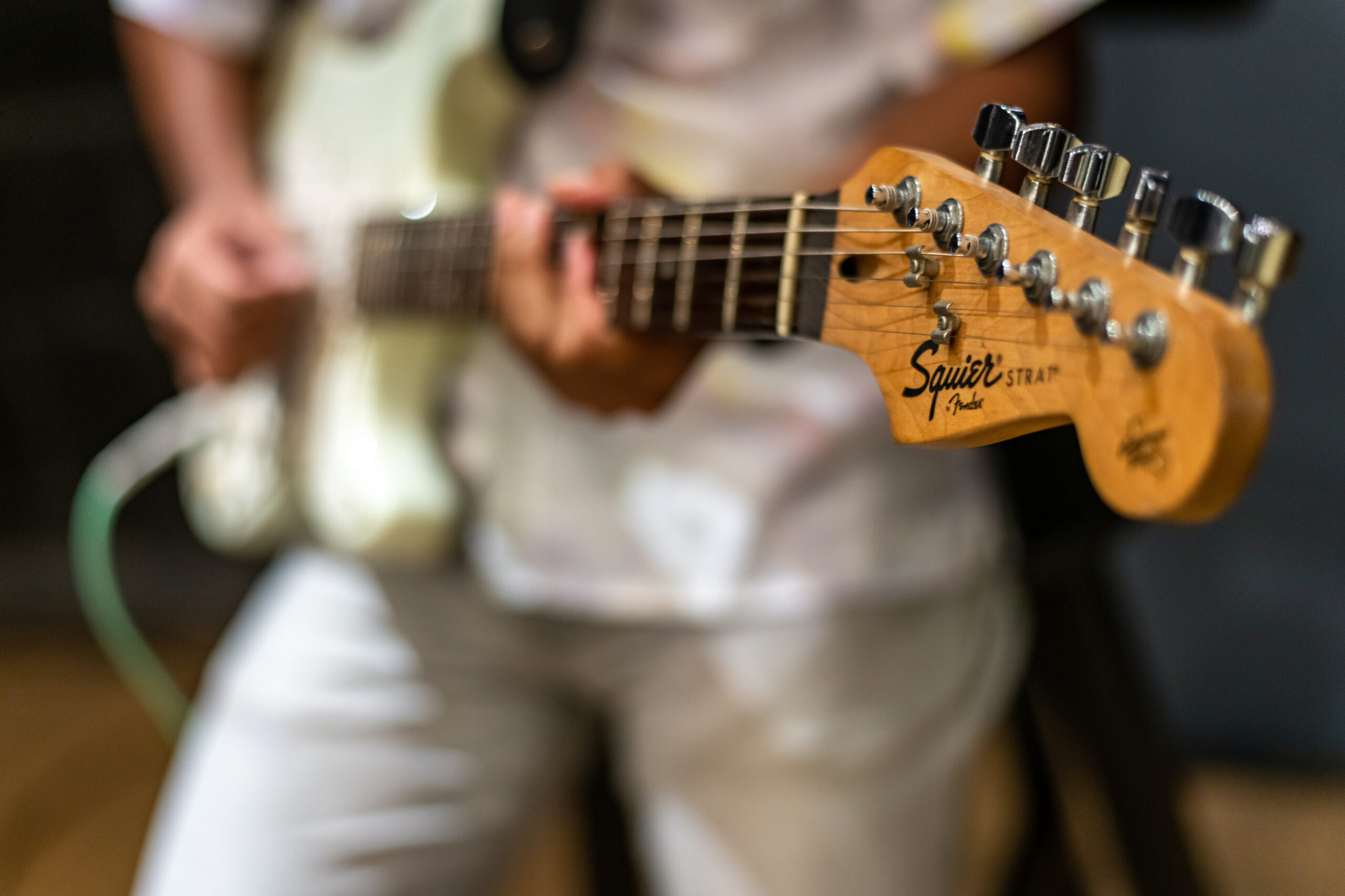Closeup of a man playing an electric guitar